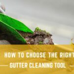A collection of professional gutter cleaning tools laid out on a wooden surface.